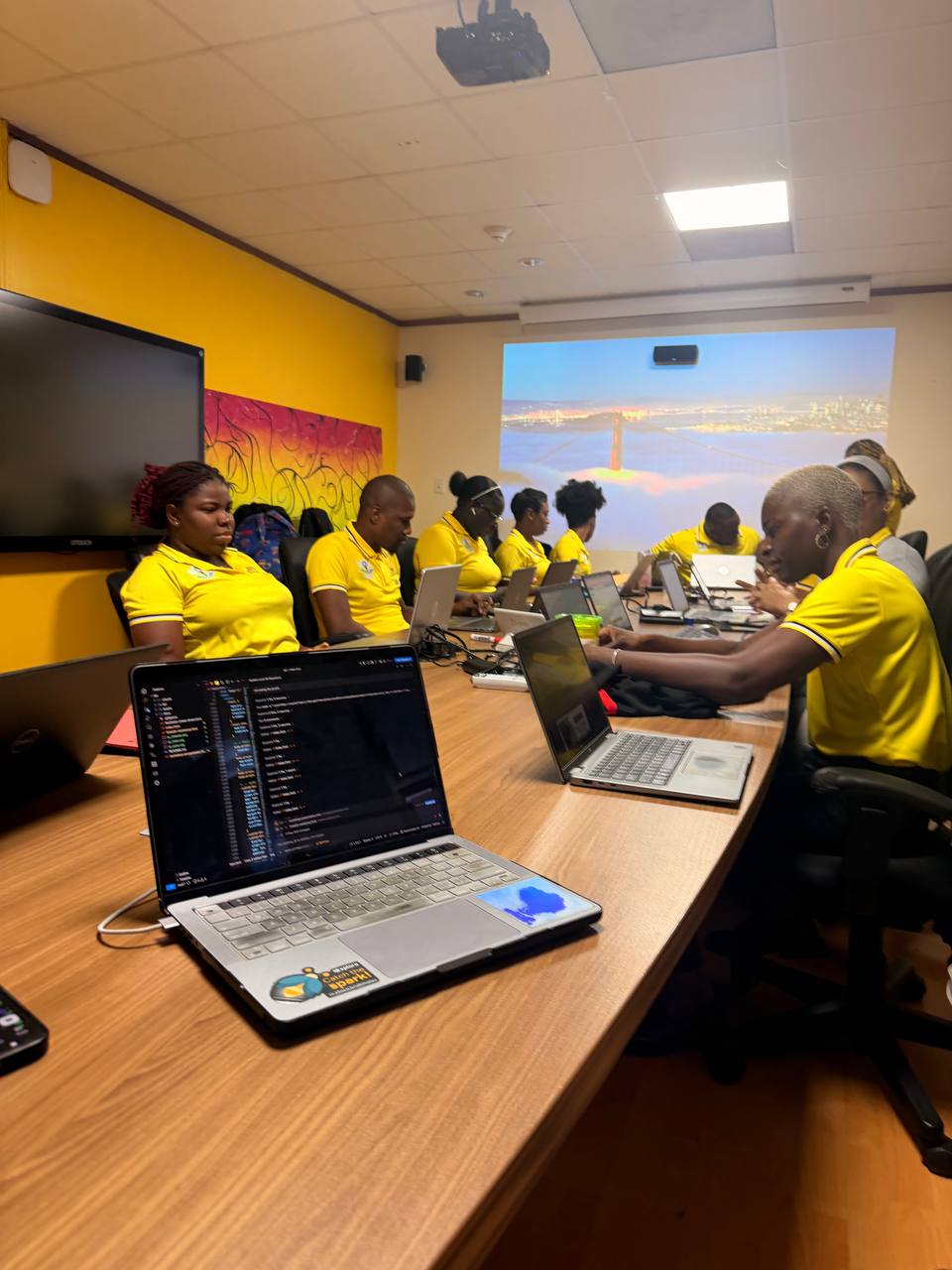 JPS staff working hands-on during the AI workshop — laptops open, everyone building, nobody watching a presentation